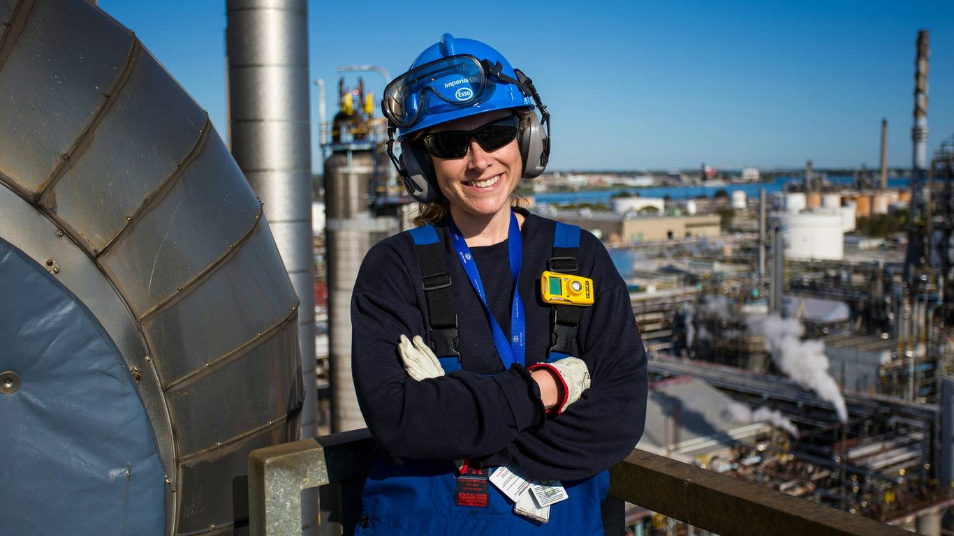 Woman engineer smiles, working in a plant.