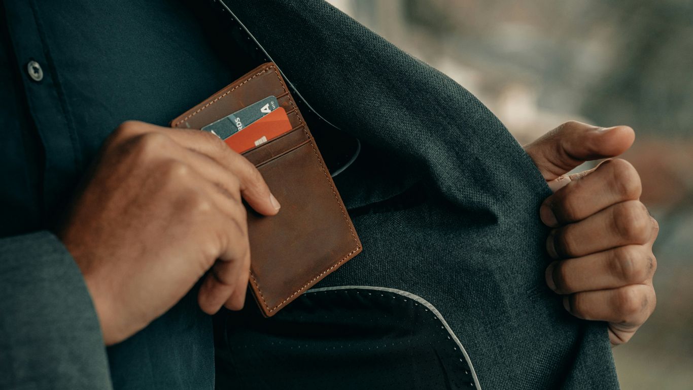 a man holding a wallet in his pocket