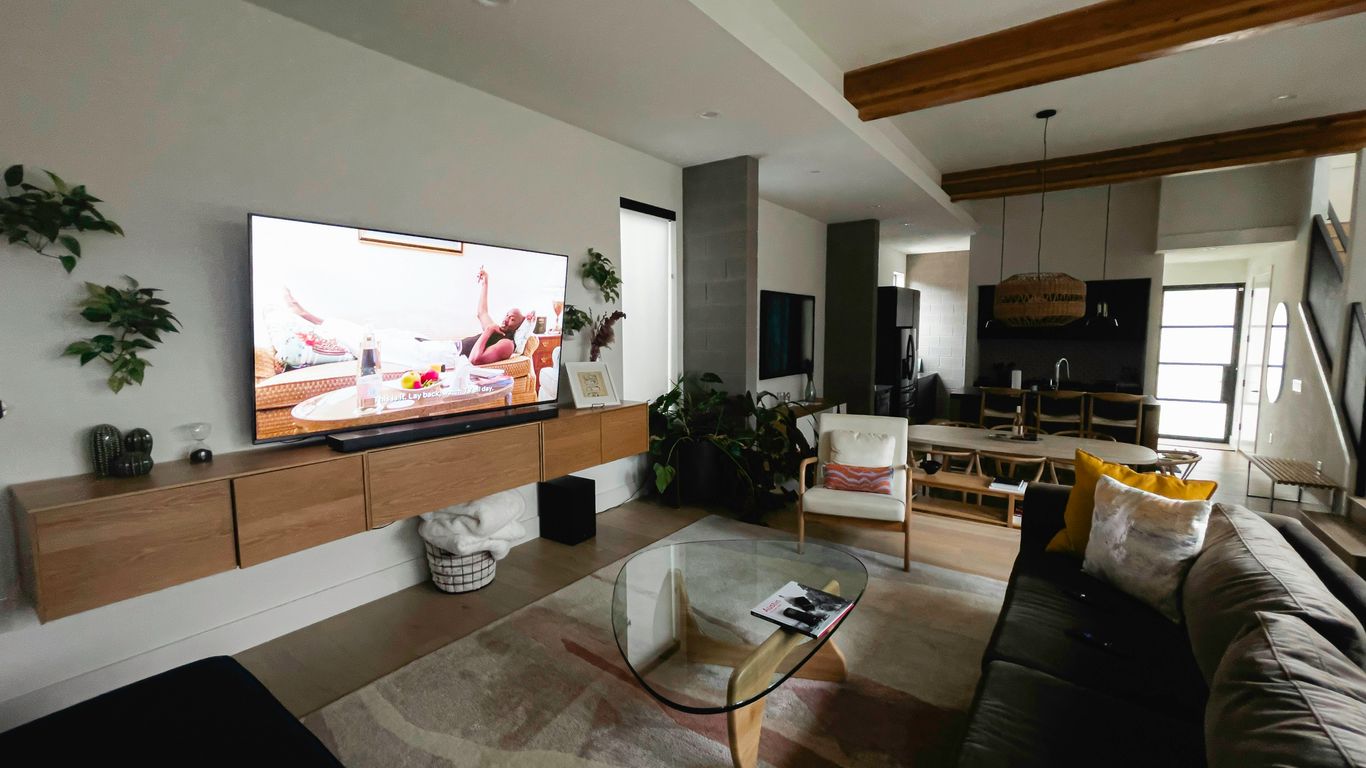 A living room filled with furniture and a flat screen TV