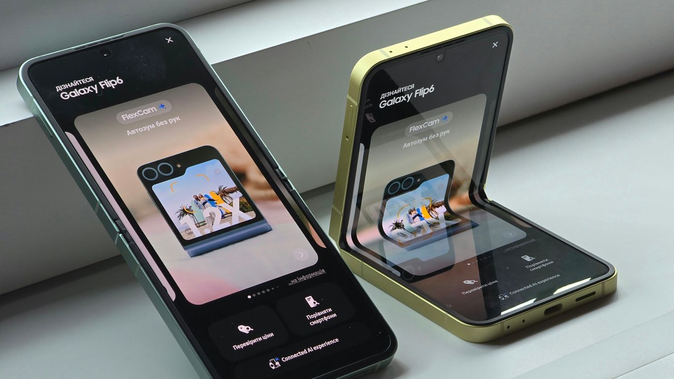 Two cell phones sitting next to each other on a window sill