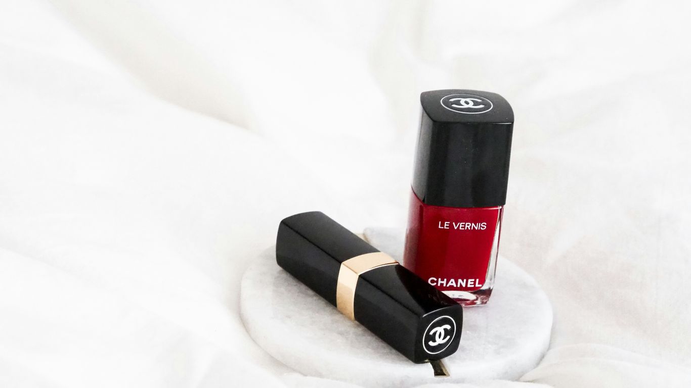 black and red lipstick on white textile