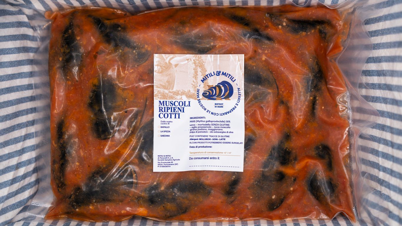 a bag of food sitting on top of a bed