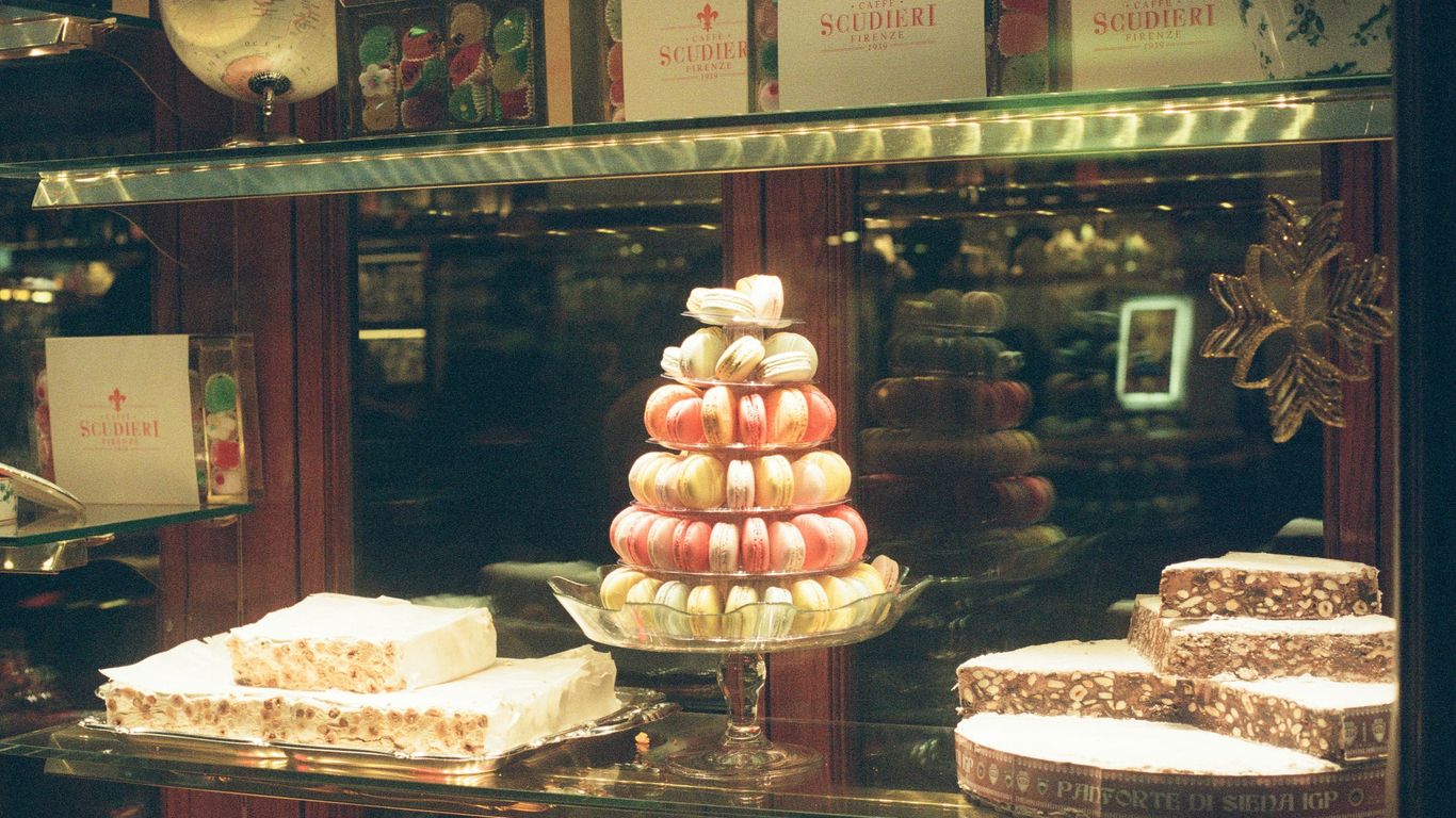 a display case filled with lots of different types of cakes