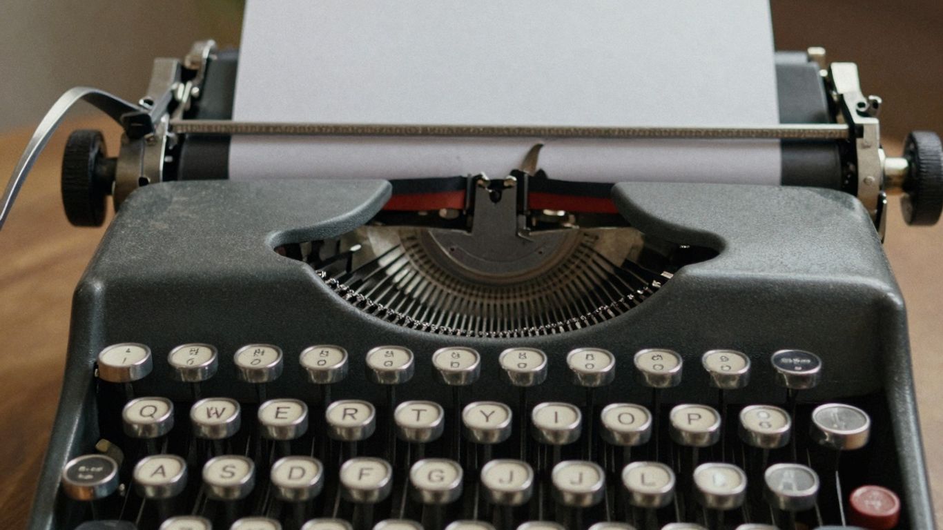 Typewriter with blank paper for Instagram captions.