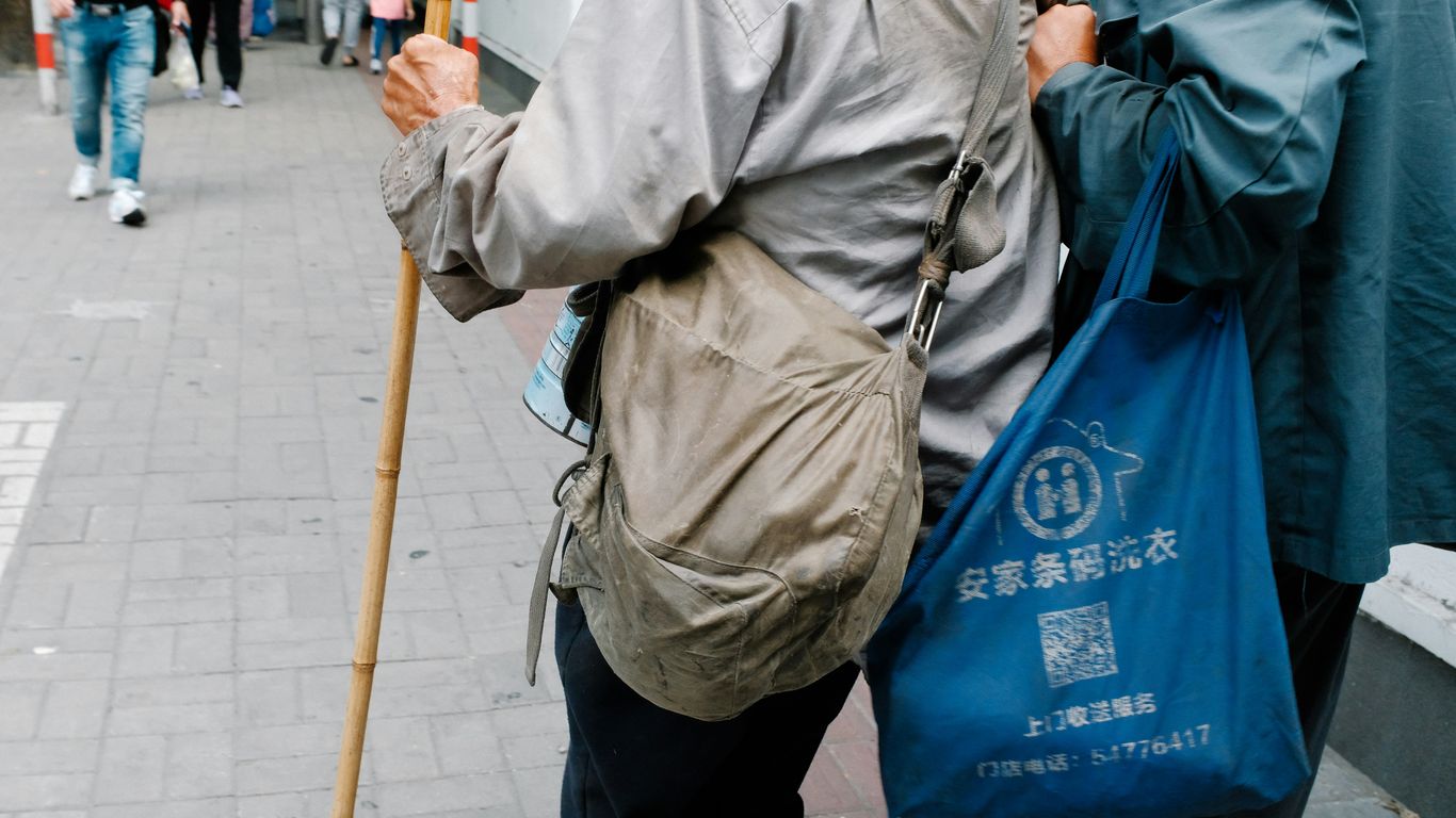 a couple of people walking down a street