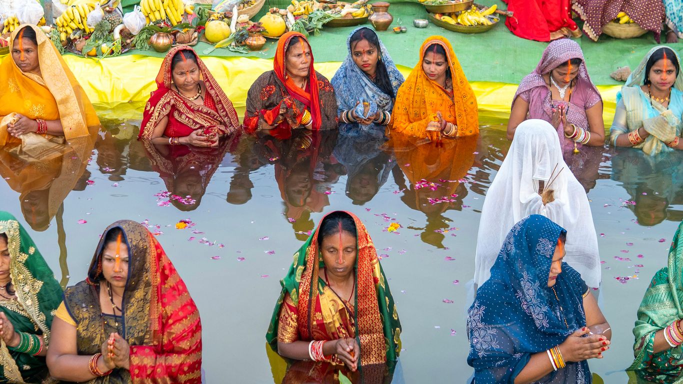 Women praying in a body of water