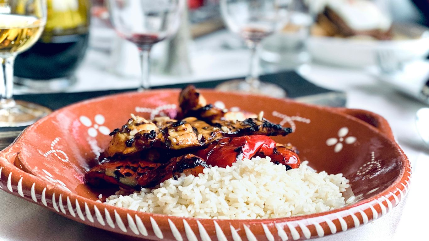 chicken and white rice on orange ceramic plate