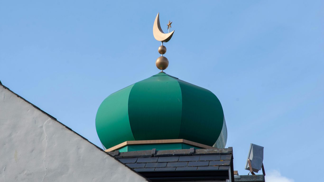 a green dome with a crescent on top of it