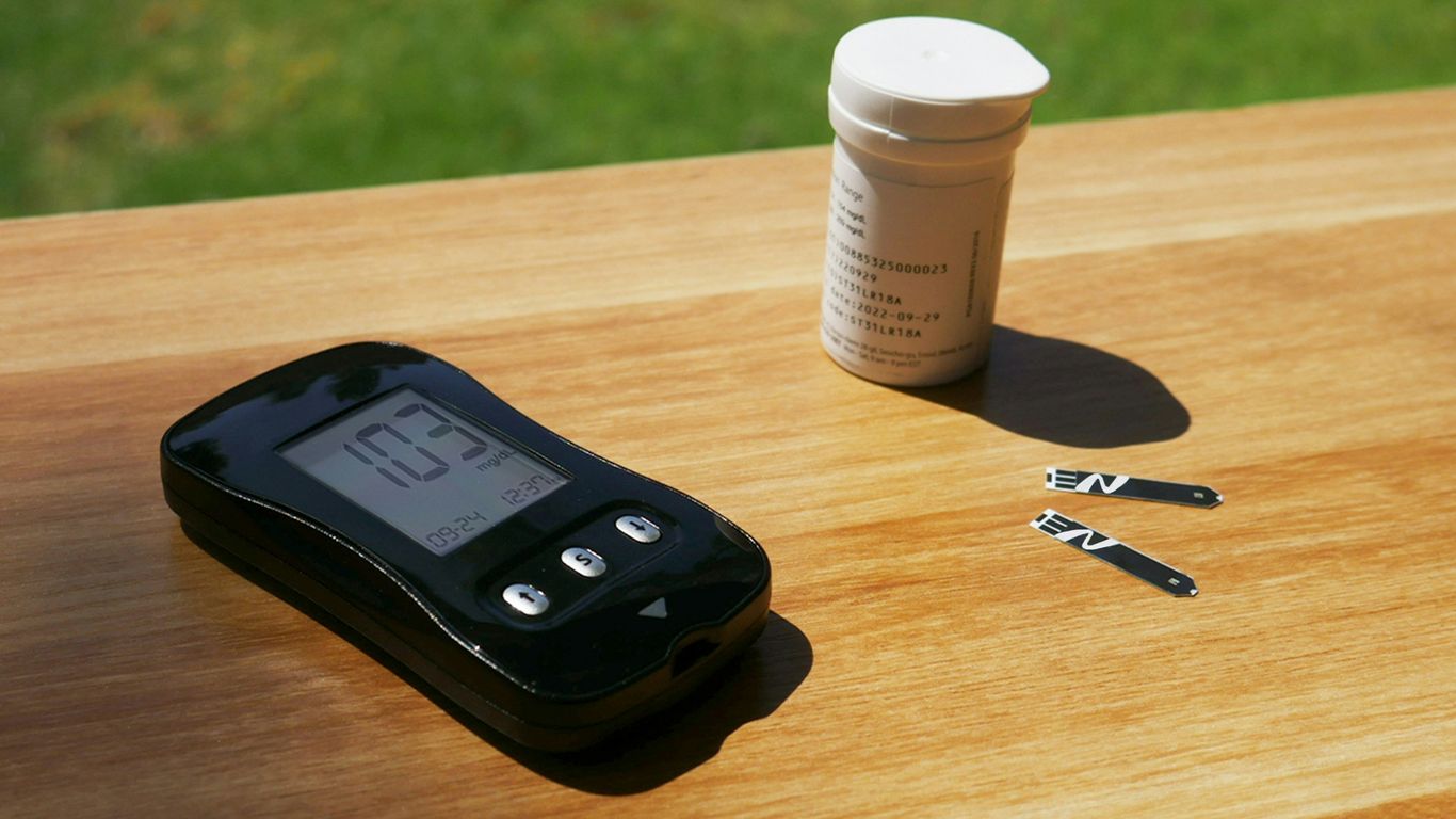 a cell phone sitting on top of a wooden table