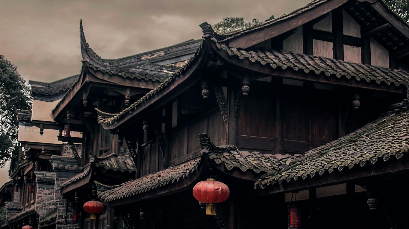Traditional Chinese architecture with ornate roofs and red lanterns.