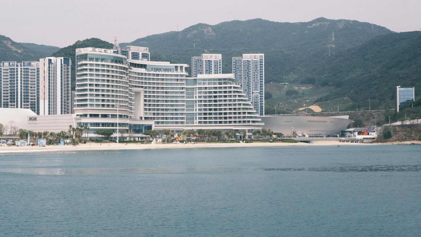 Coastal city skyline with buildings and water.