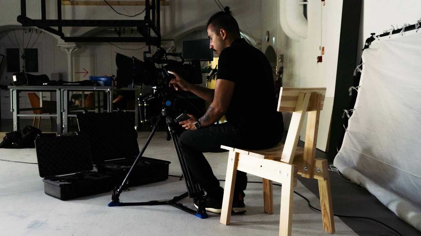 a man sitting in a chair in front of a camera