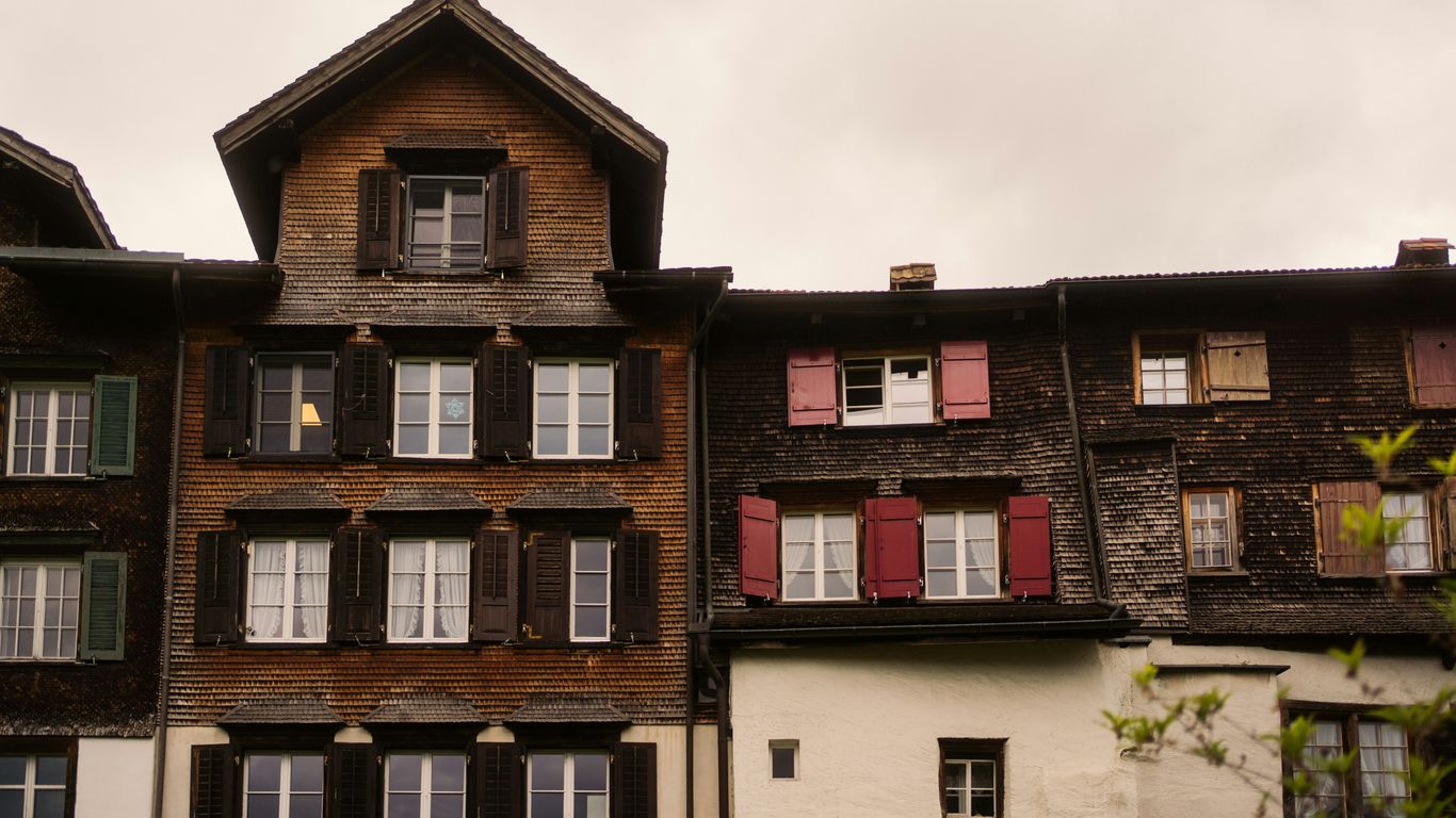 Old european buildings with shuttered windows are shown.