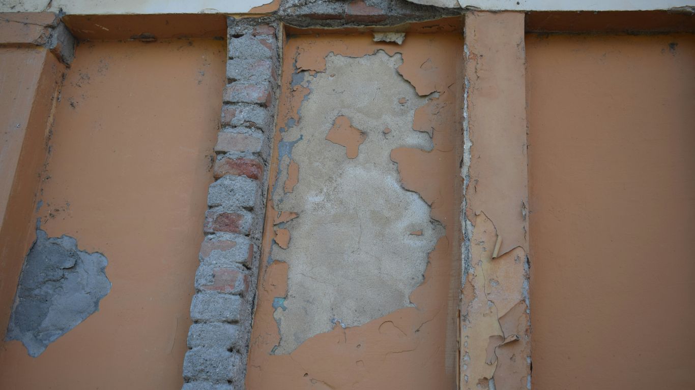 a brick wall with a hole in the middle of it