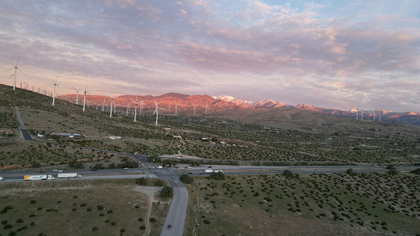 An aerial view of a road and windmills