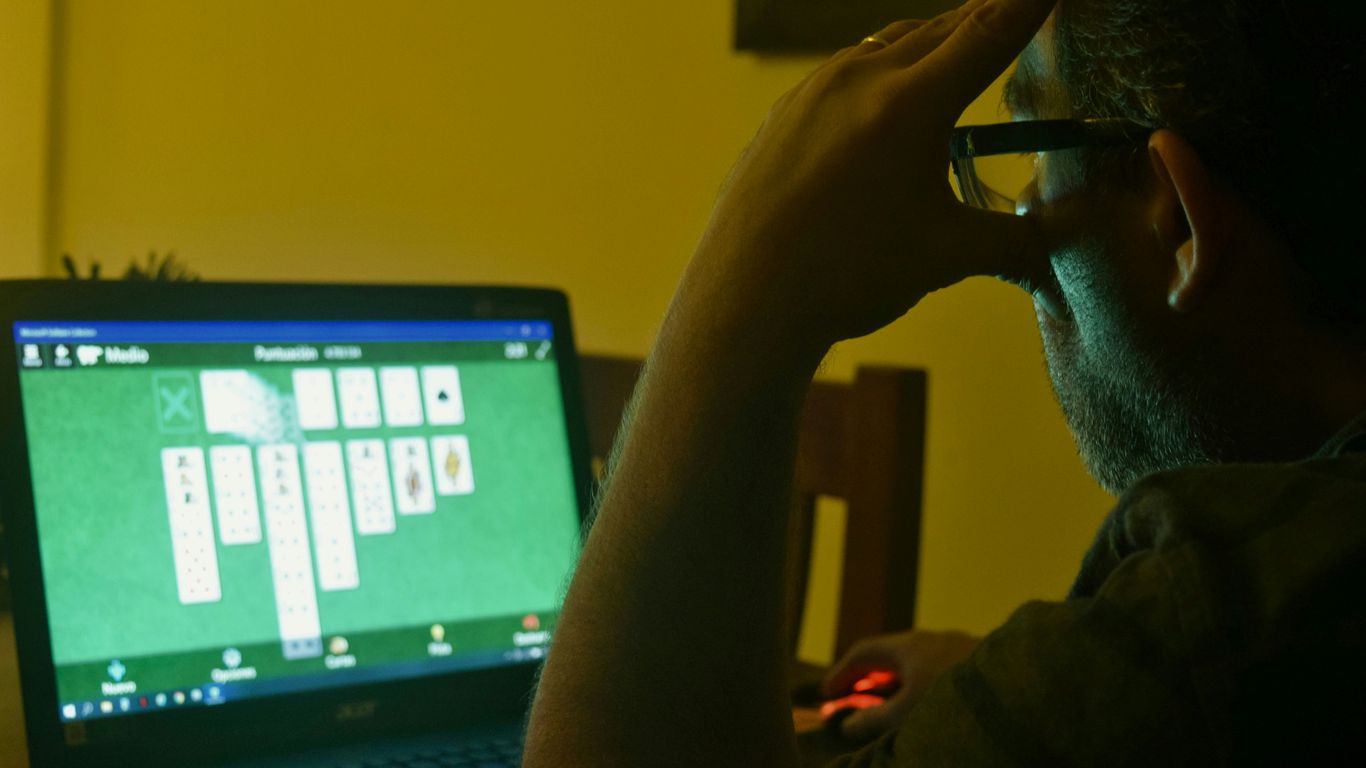 a man sitting in front of a laptop computer
