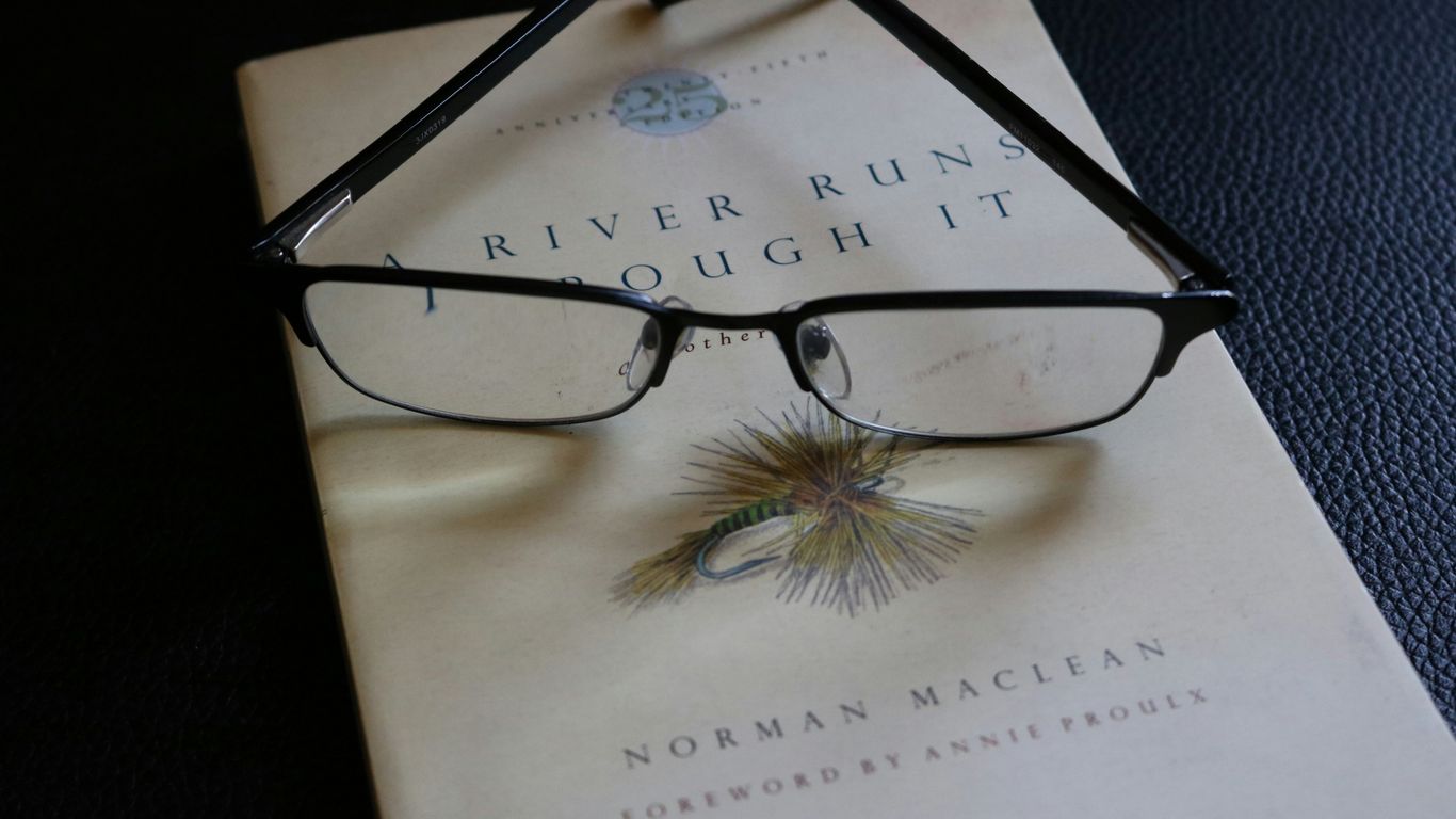 a book with a pair of glasses on top of it
