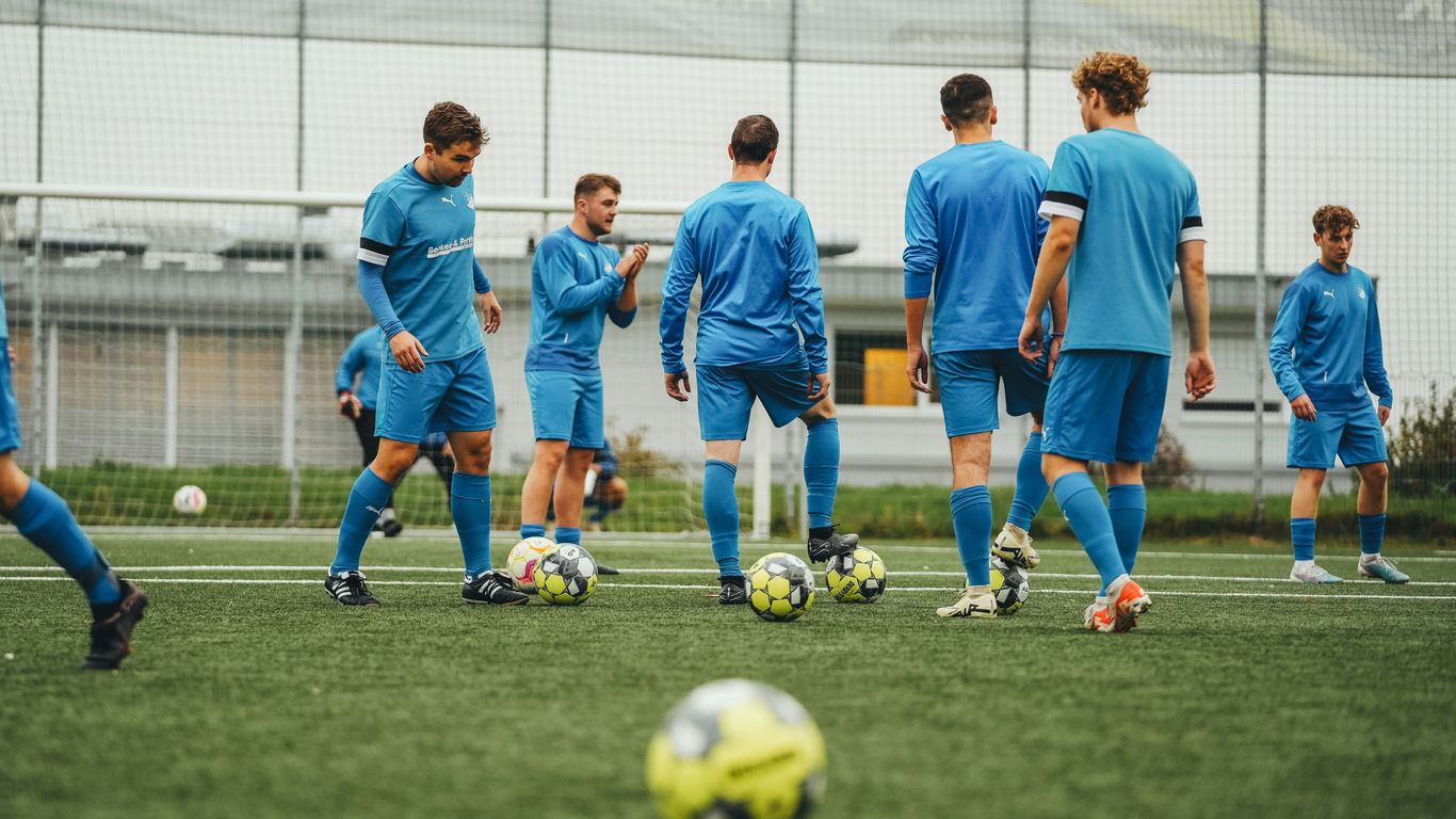A group of young men playing a game of soccer