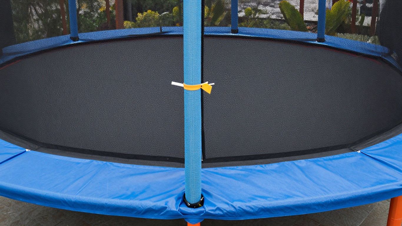 Trampoline assembly complete with safety netting and padding installed.