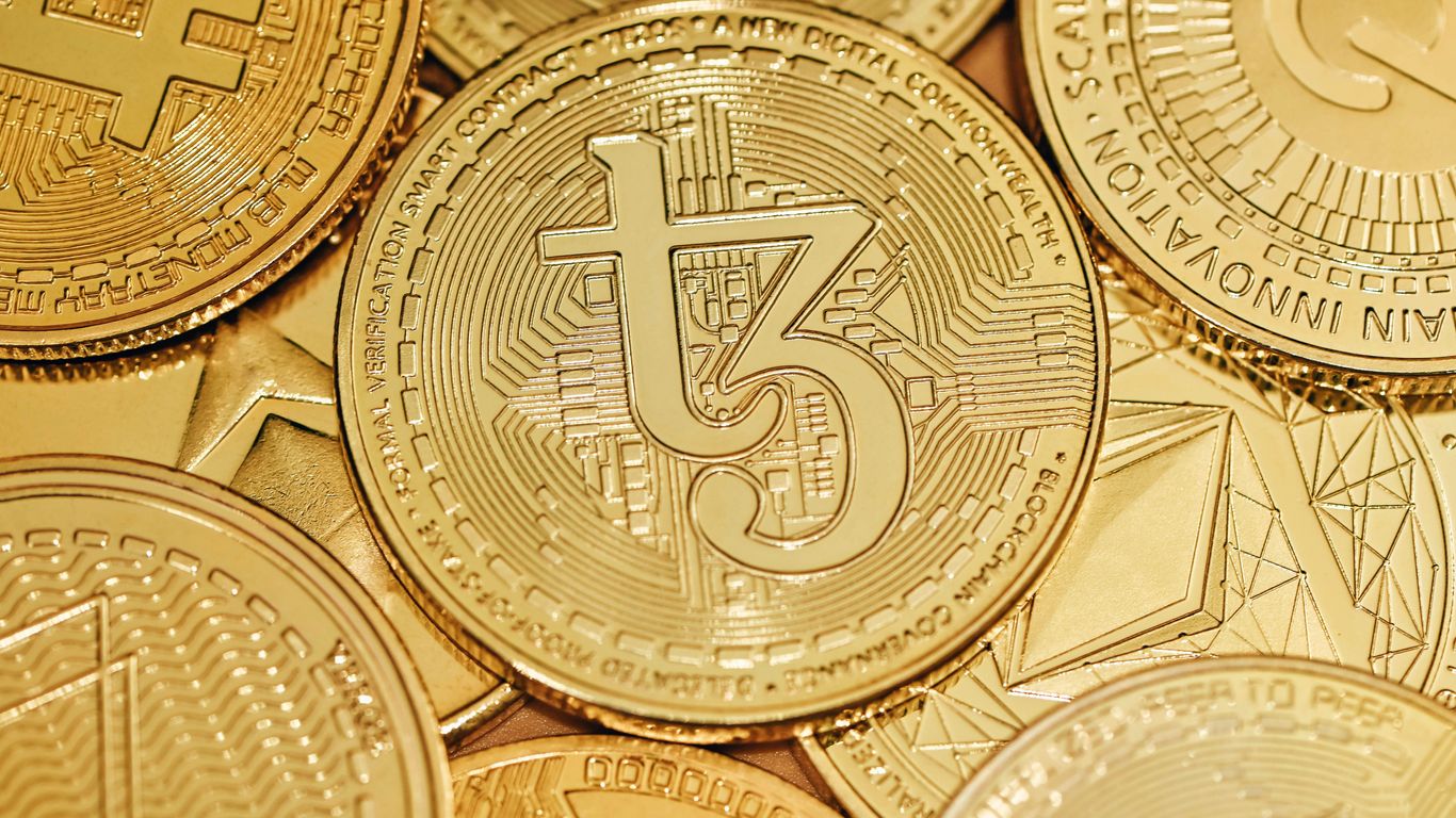 Several gold cryptocurrency coins, prominently featuring the symbol "t3."