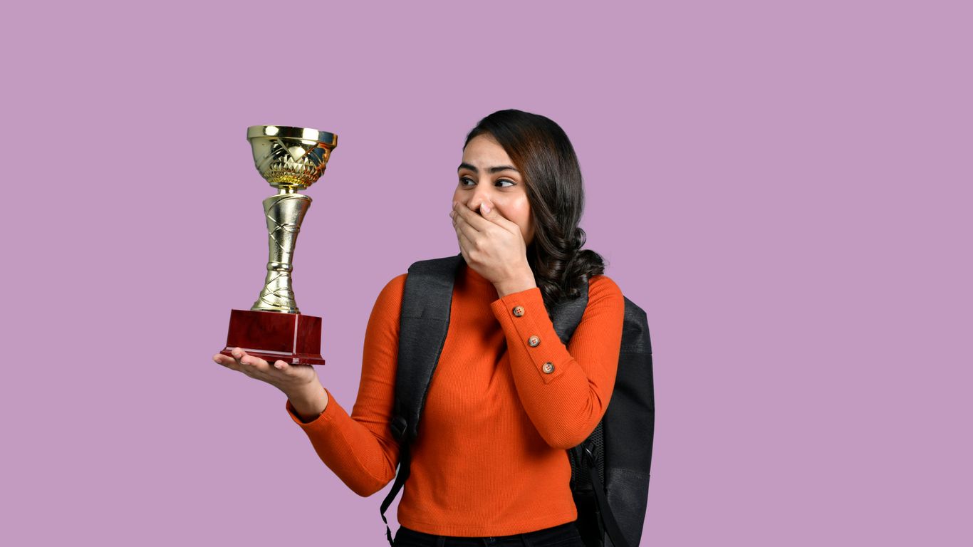 a woman holding a trophy
