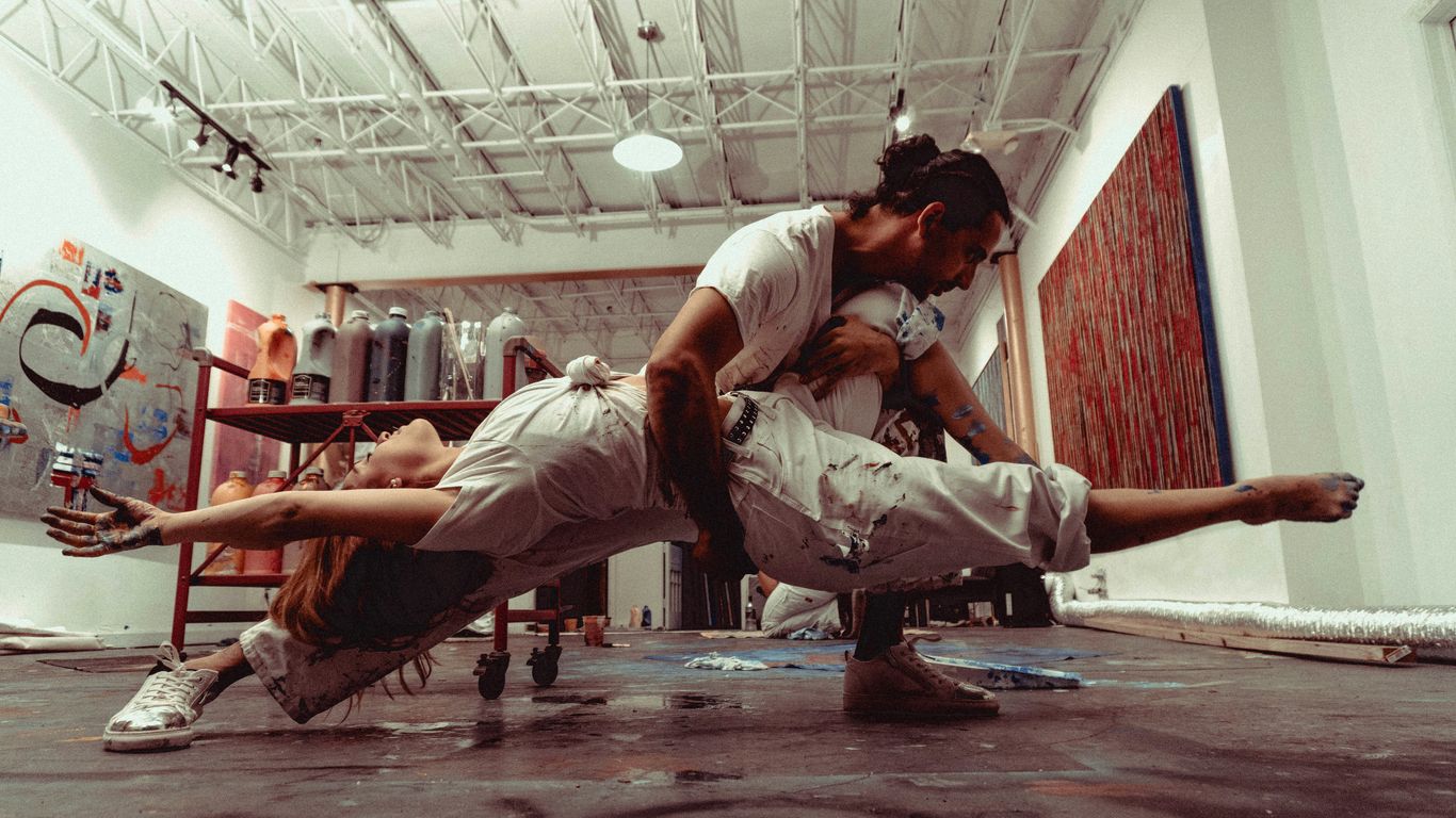 man in white t-shirt and gray pants doing push up