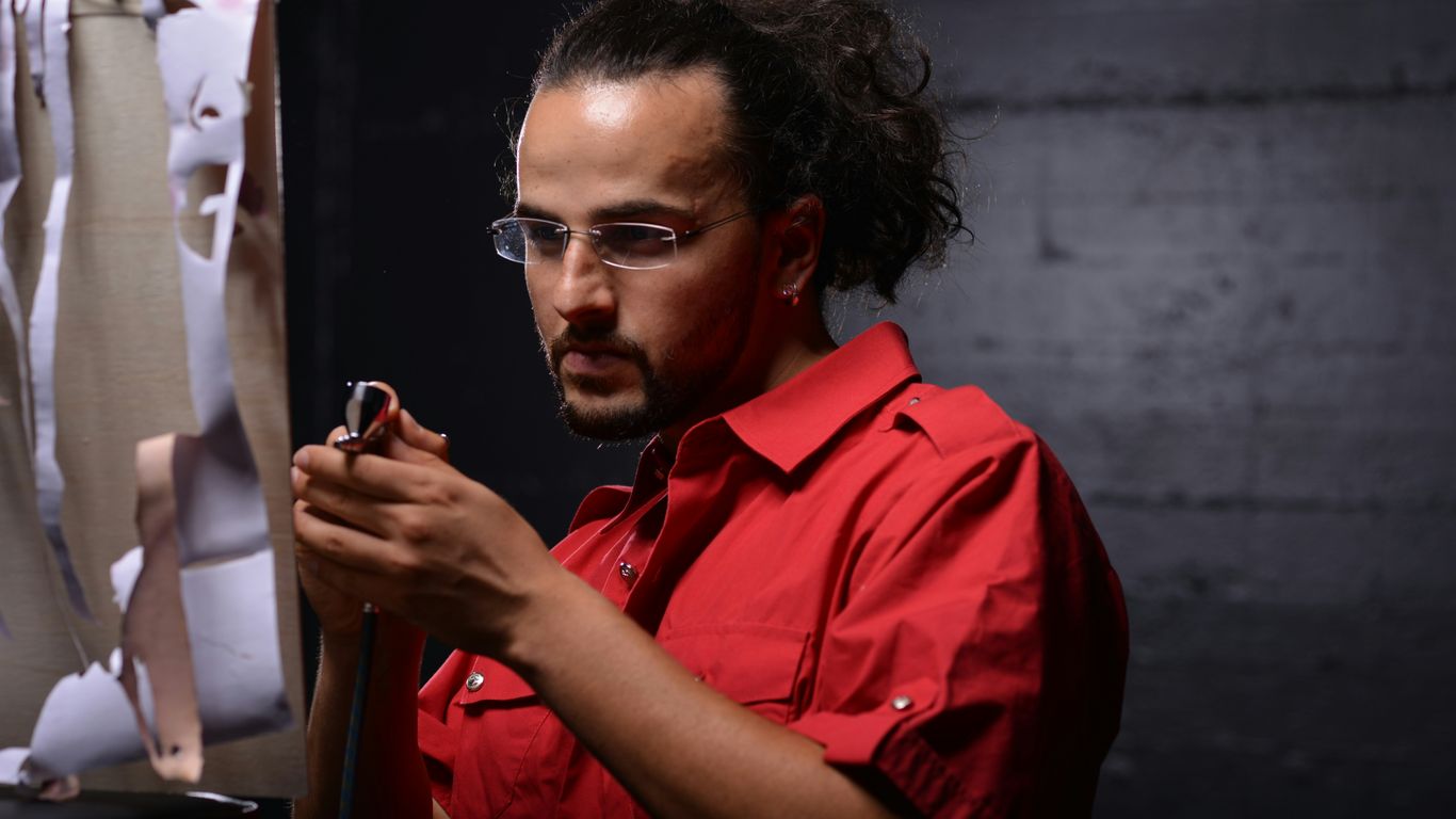 man in orange button up shirt wearing black framed eyeglasses