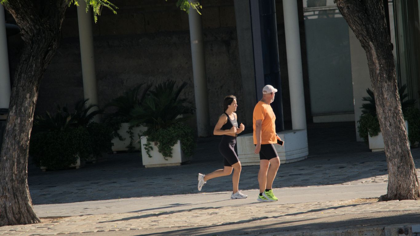 A man and a woman running down a street