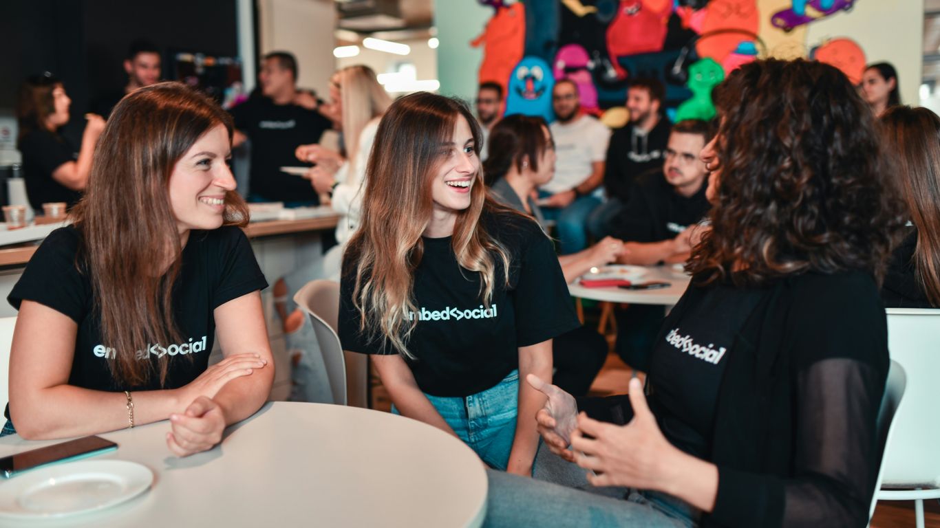 a group of people sitting around a table talking