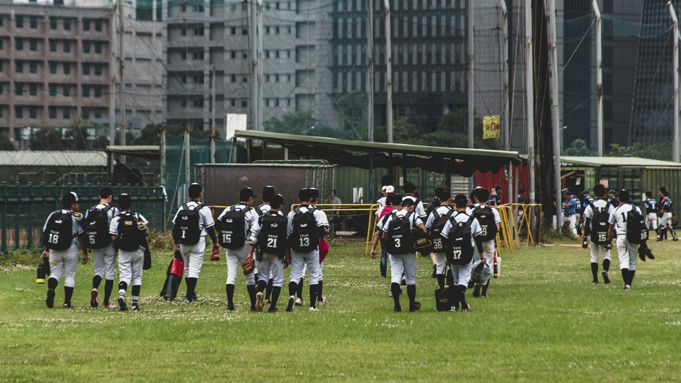 people in black and white uniform on green grass field during daytime