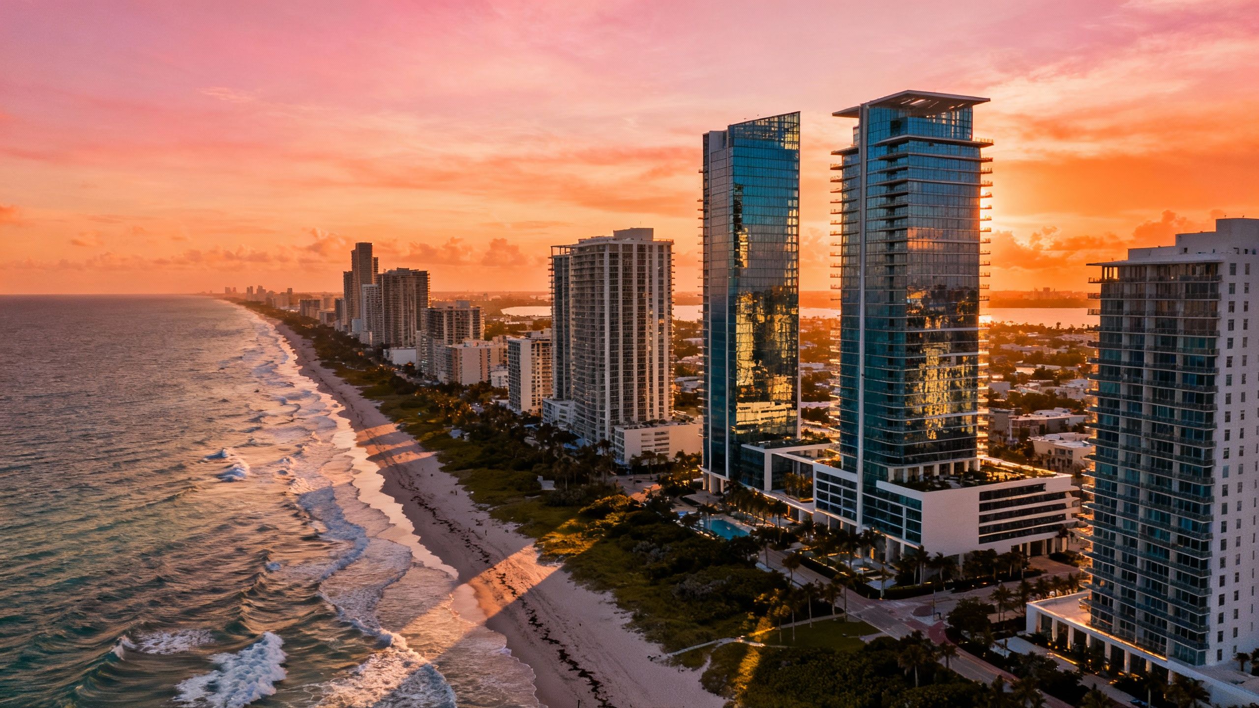 Sunset aerial view of Miami Beach coastline showing new luxury condo towers