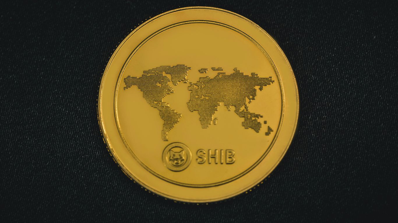 a gold coin with a world map on it