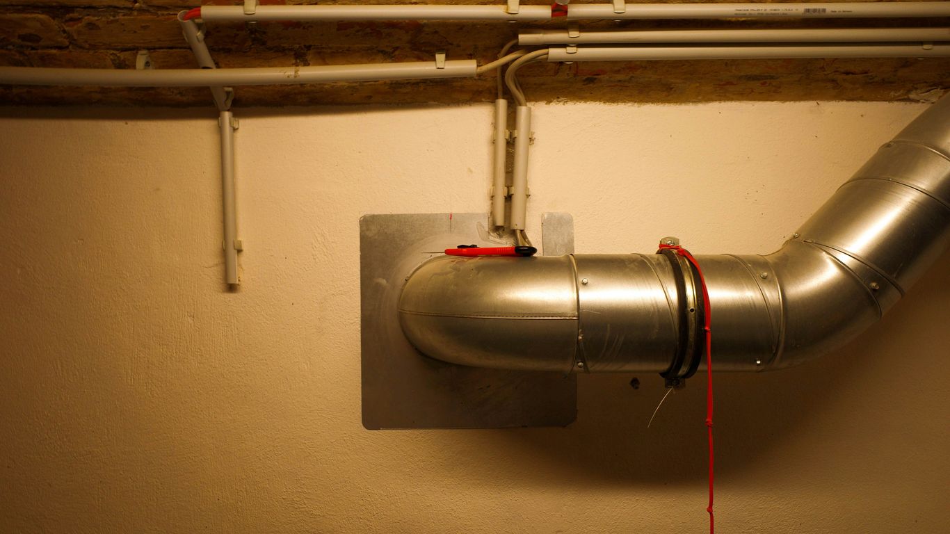 A metal pipe is attached to a wall