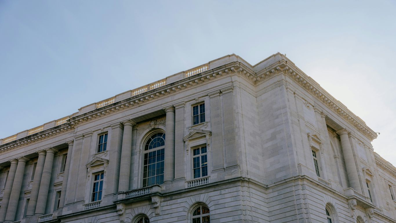 A large white building with a sky background
