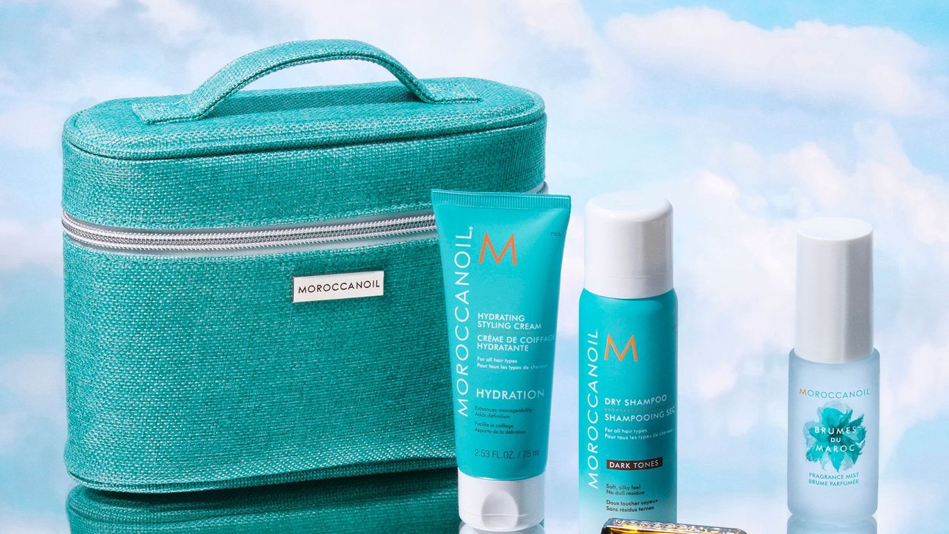 Moroccanoil haircare products displayed with a teal cosmetic bag.