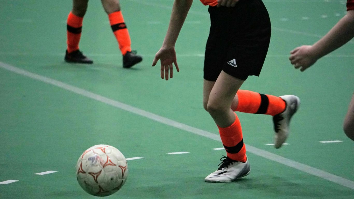 a group of young people playing a game of soccer