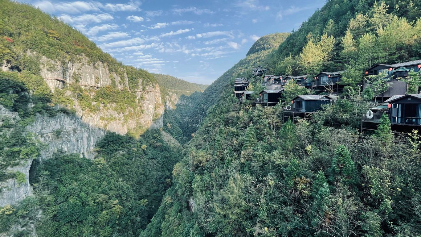 a scenic view of a mountain with cabins on it