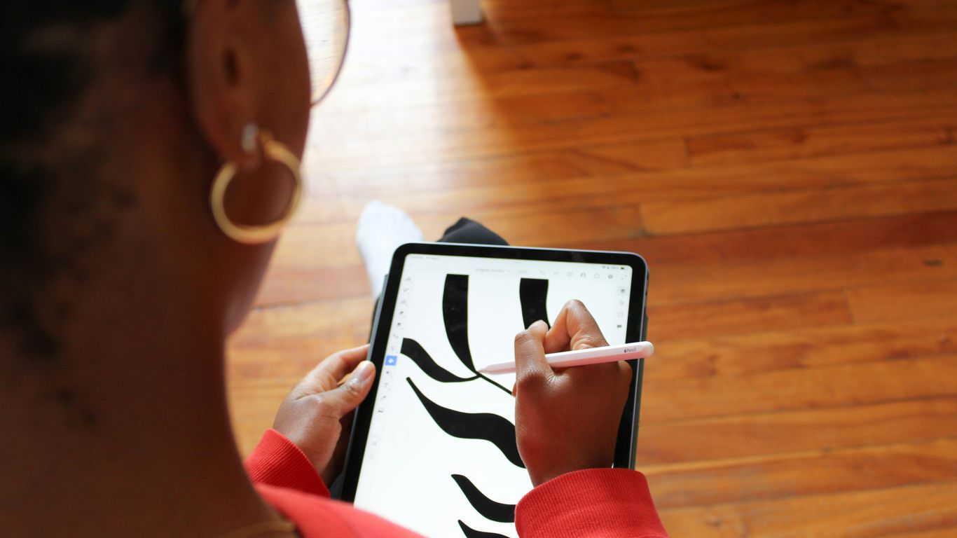 a woman holding a tablet with a zebra pattern on it