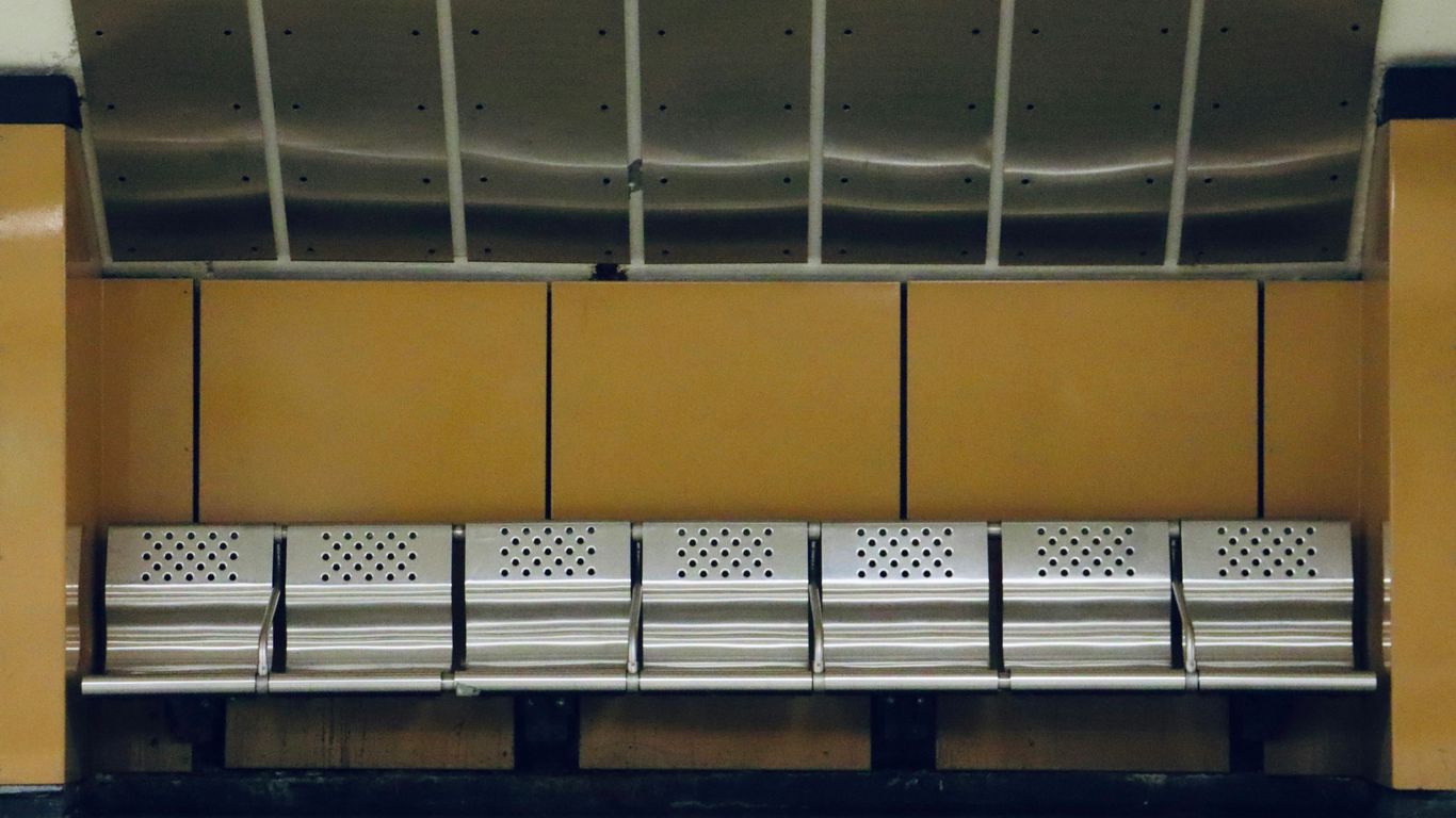 a row of metal benches in a building