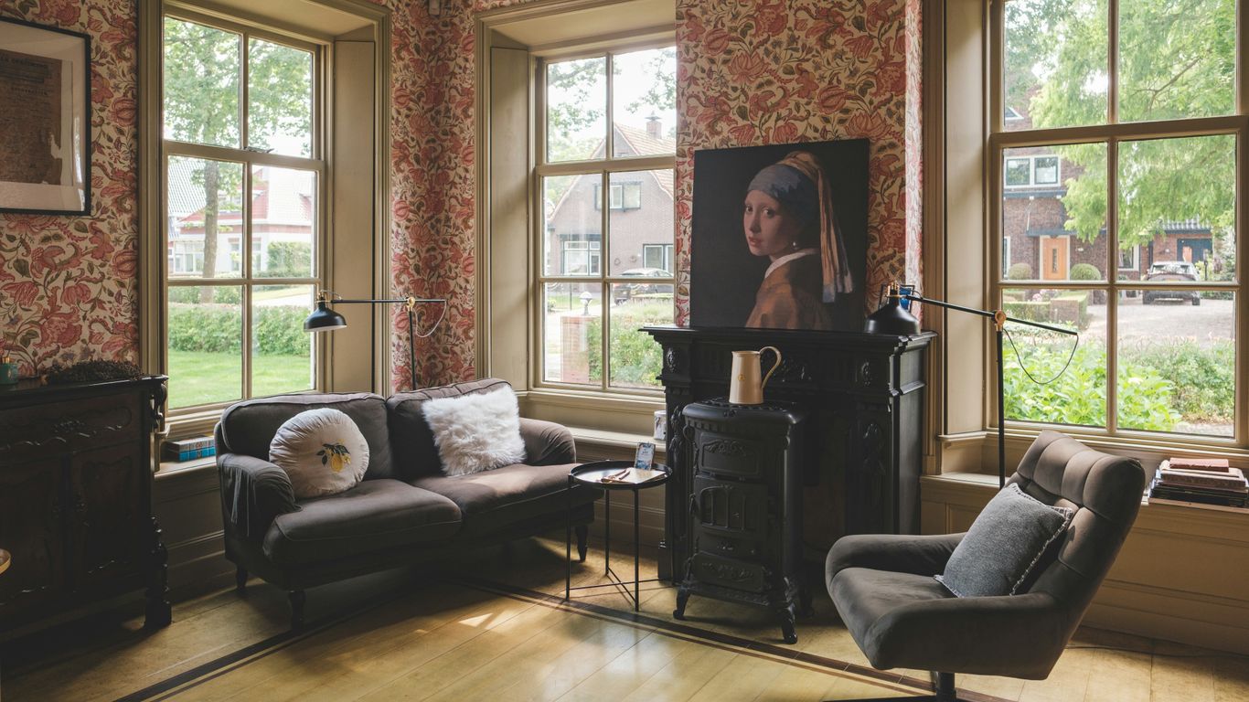 A cozy living room with an artwork on the wall.