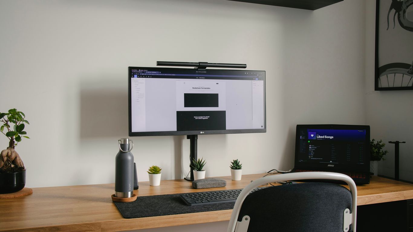 black flat screen tv mounted on white wall