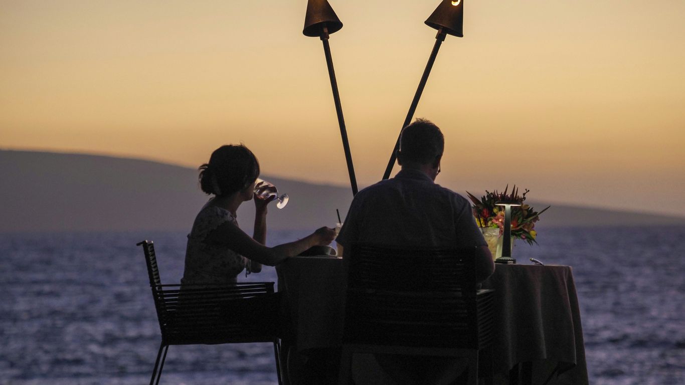 a man and a woman sitting at a table next to each other