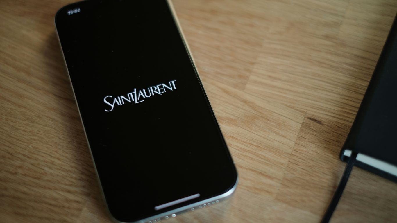 A cell phone sitting on top of a wooden table