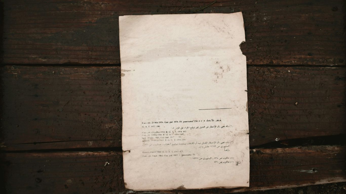 white printer paper on brown wooden surface