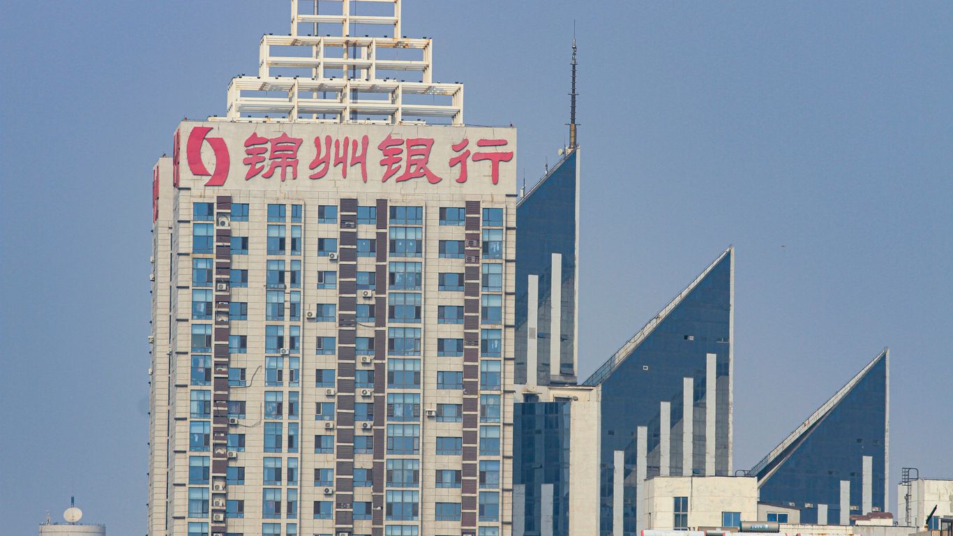 a tall building with a red and white sign in front of it
