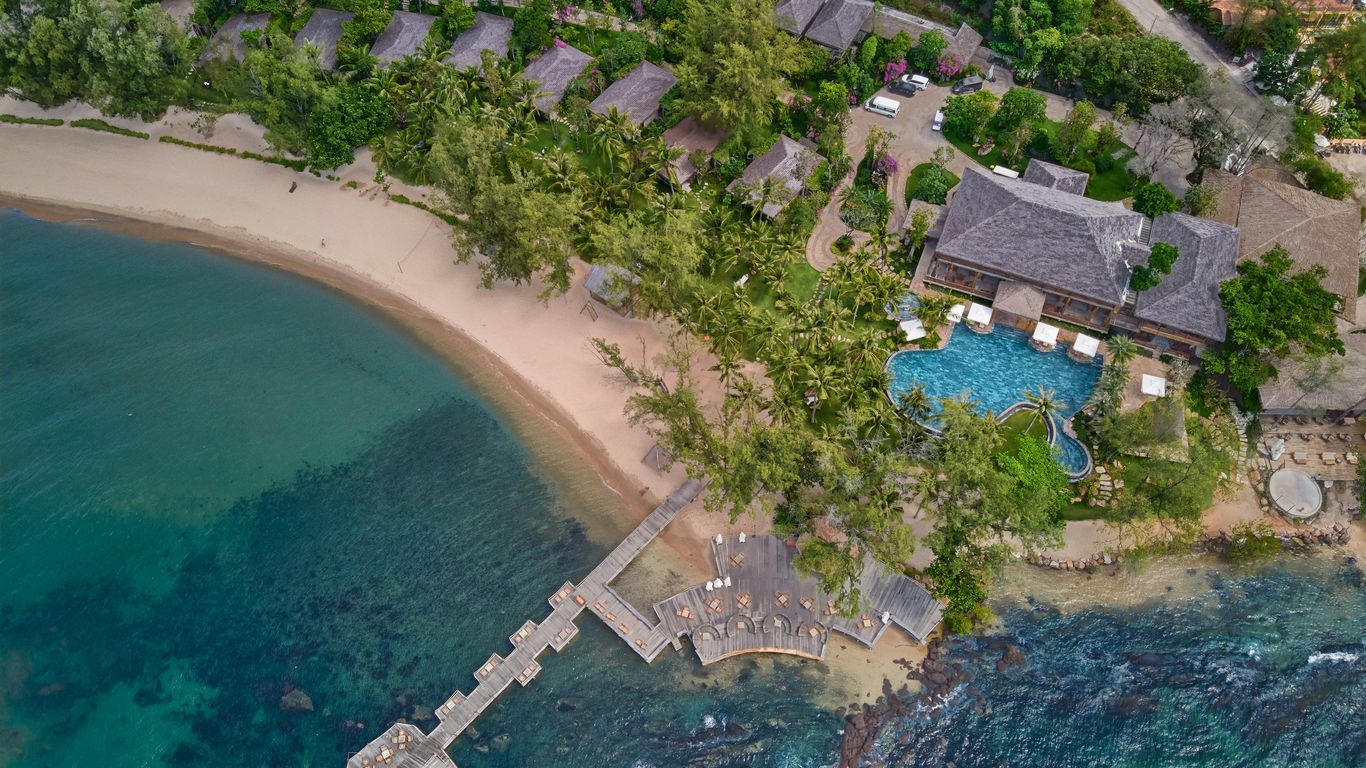 an aerial view of a resort on the ocean