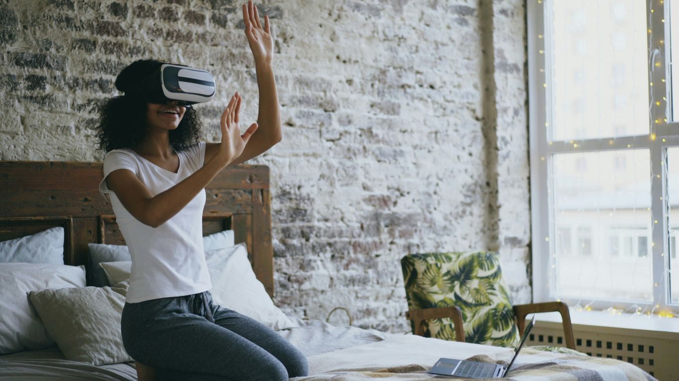 Woman wearing vr headset interacting with virtual reality