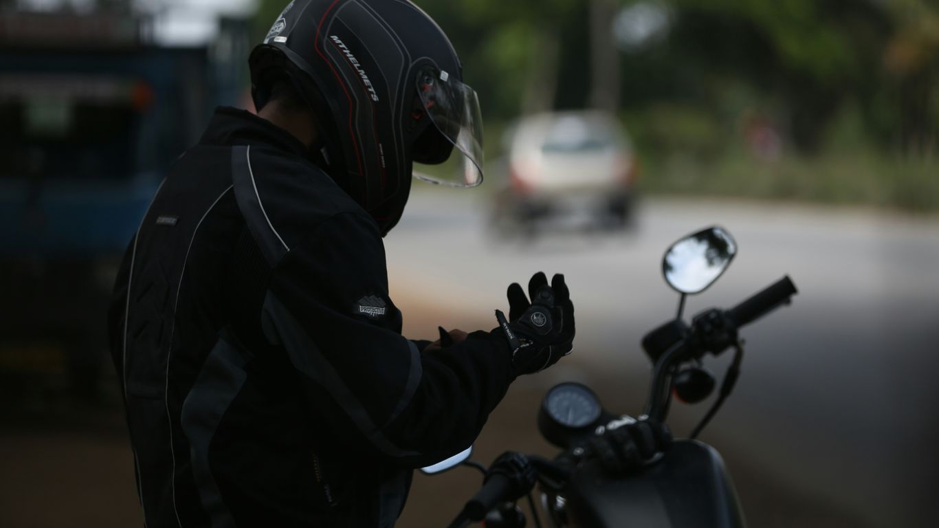 selective focus photo of man wearing motorcycle suit