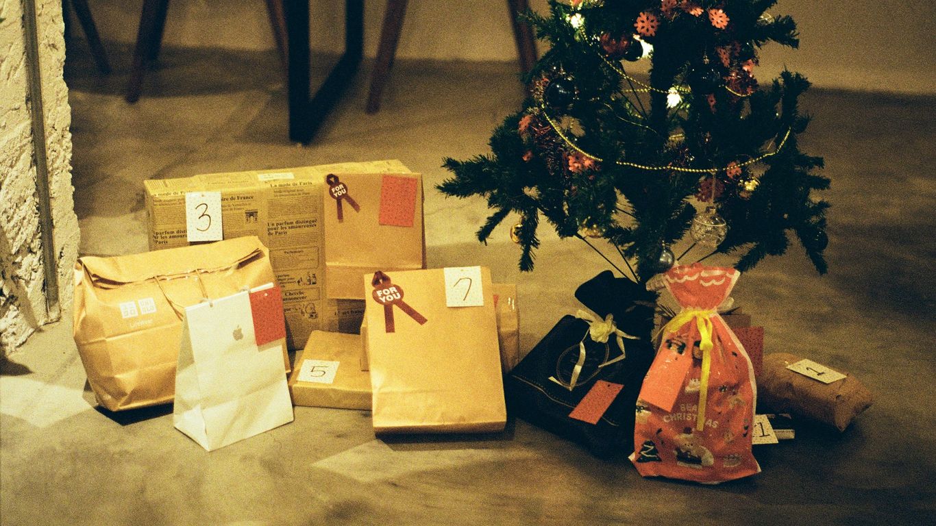 a small christmas tree with presents under it