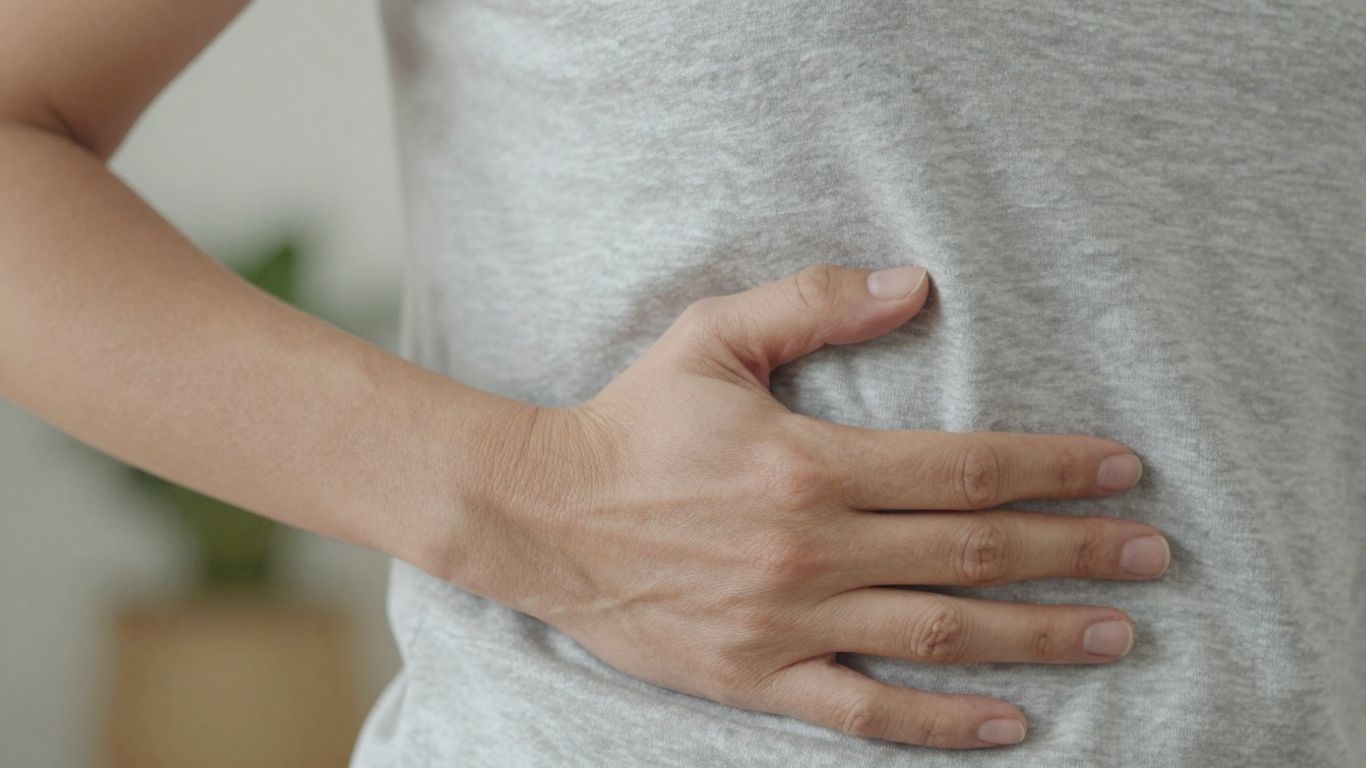 Person holding hip in pain